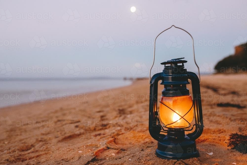 Kerosene lamp on the beach at dusk - Australian Stock Image