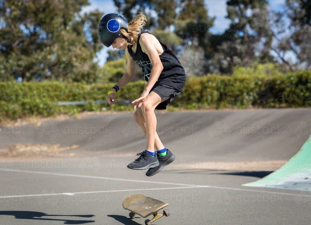 Kid jumping on a skateboard - Australian Stock Image