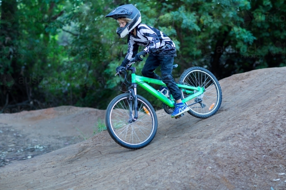 Kid on bike wearing helmet - Australian Stock Image