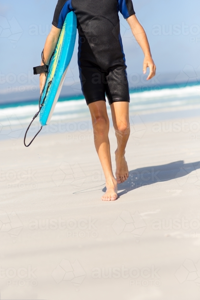 Kid on the beach with his boogie board - Australian Stock Image