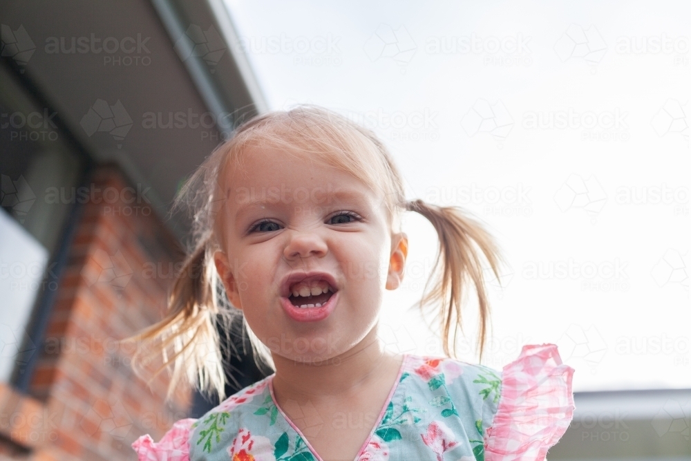 Image of Kid pulling silly smile face - Austockphoto