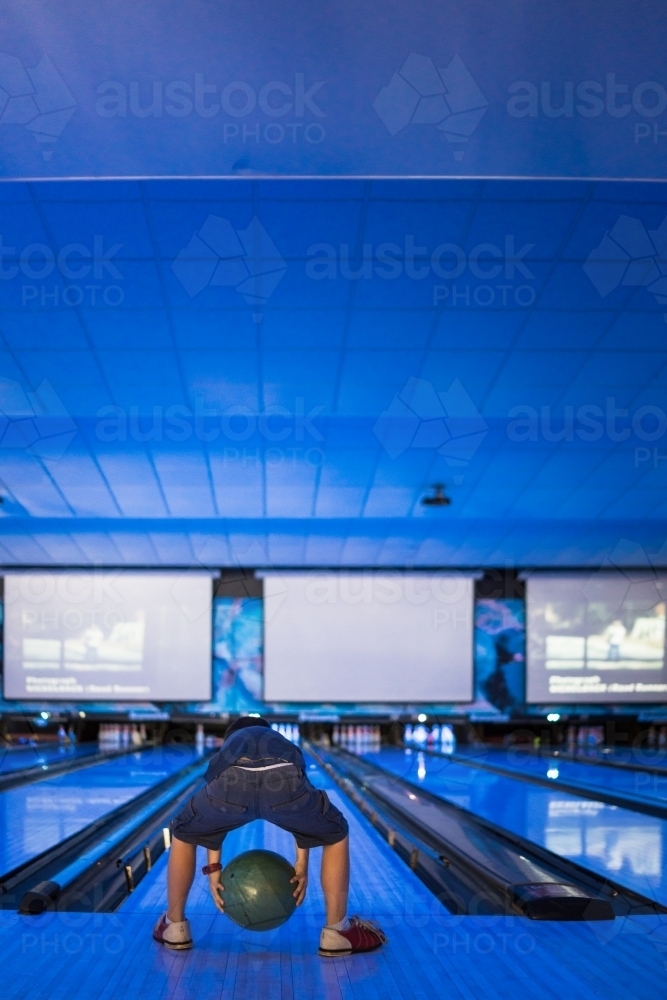 Kids 10 pin bowling under blue lights - Australian Stock Image