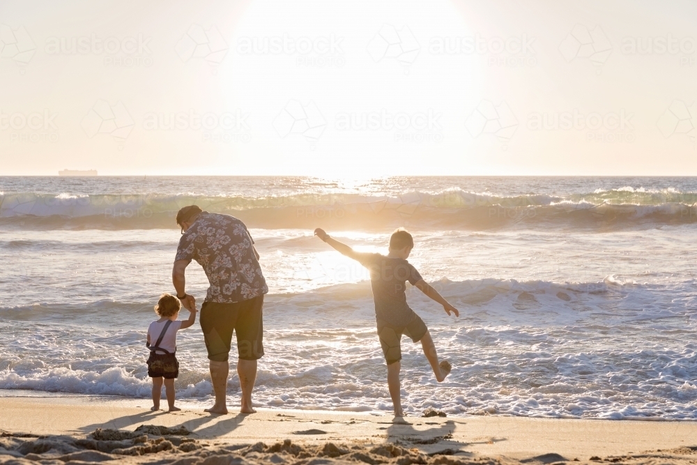 Kids And Father On The Beach At Sunset - Australian Stock Image