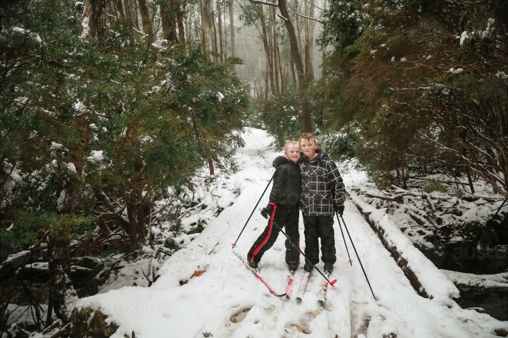 Kids cross-country snow skiing in Victoria's high country in winter - Australian Stock Image