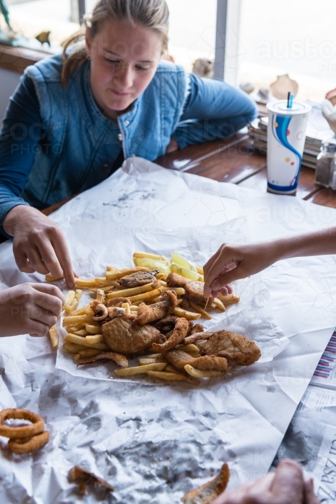 kids eating fish and chips - Australian Stock Image