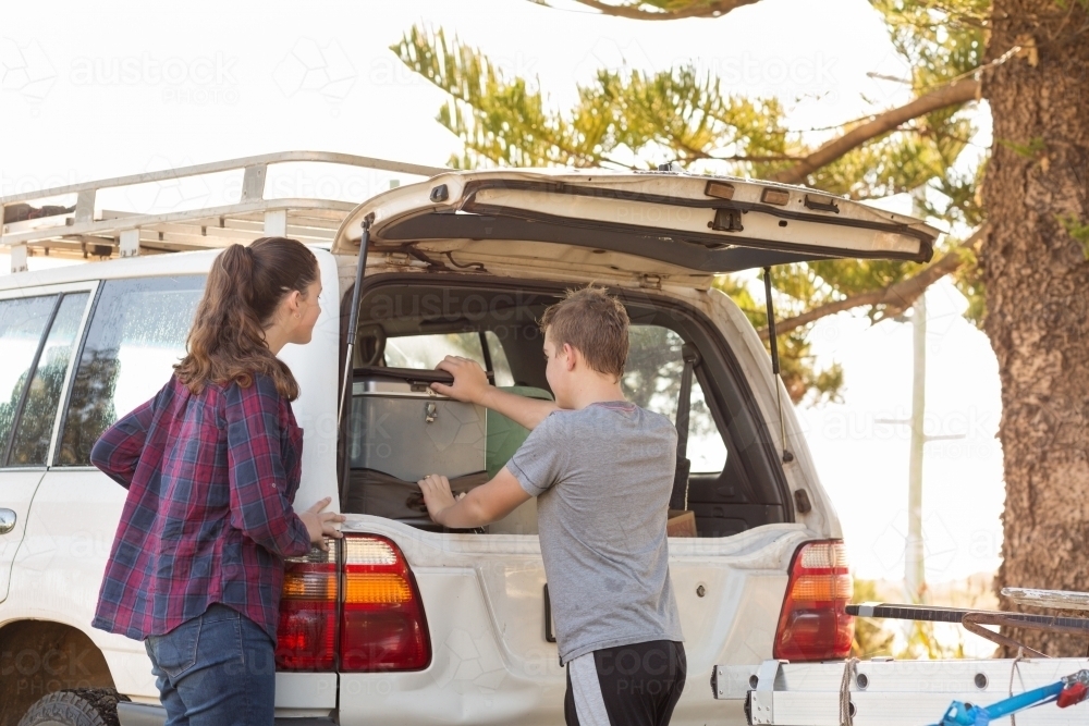 Kids getting stuff out of 4WD vehicle : Austockphoto Kids getting stuff out of 4WD vehicle - Australian Stock Image