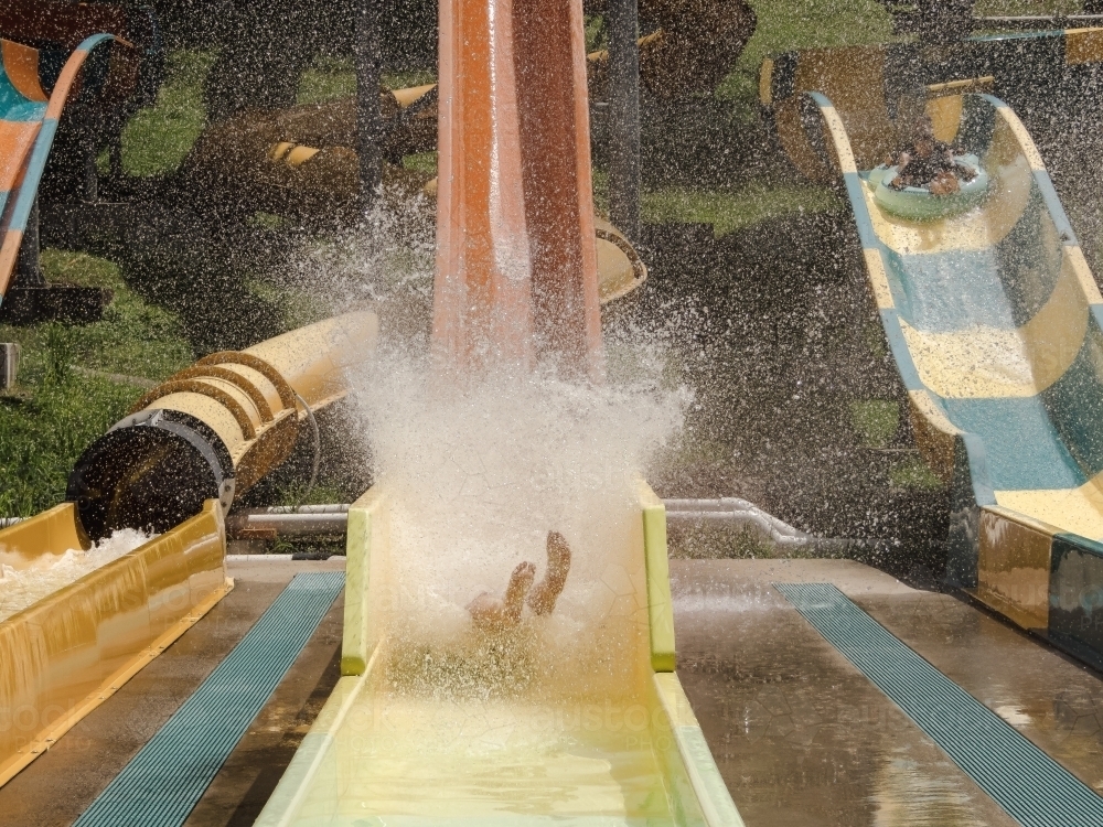 Kids having fun riding water slides on summer holiday in Coffs Harbour, Australia - Australian Stock Image