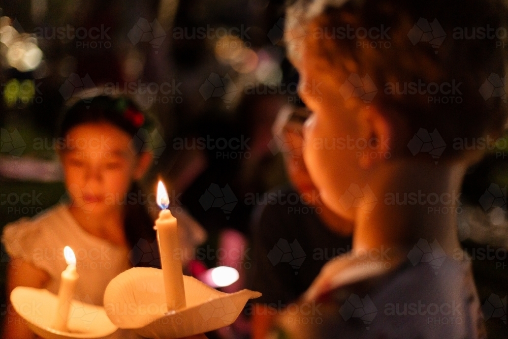kids holding real candles at carols by candlelight - Australian Stock Image