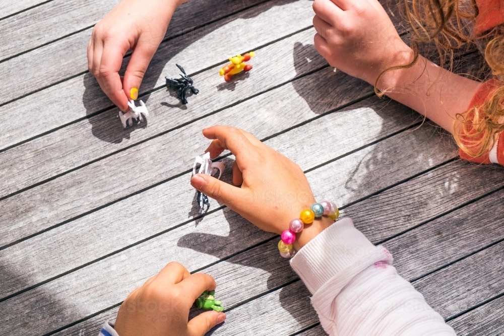 Image of Kids little hands play with toys - Austockphoto