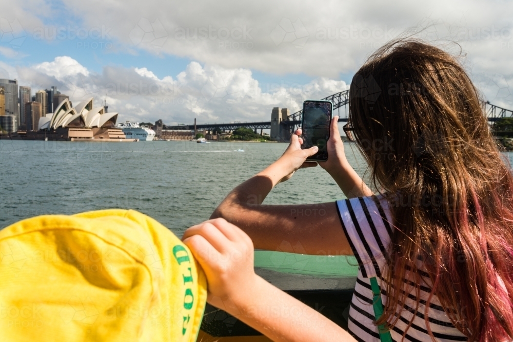 kids looking at the view of Sydney from the ferry - Australian Stock Image