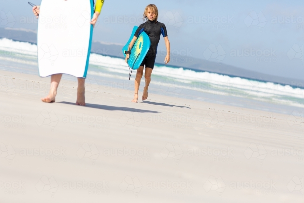 Kids on the beach with body boards - Australian Stock Image