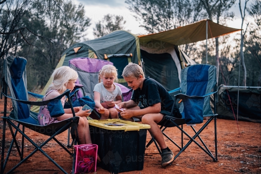 Kids playing card games at the camp ground - Australian Stock Image