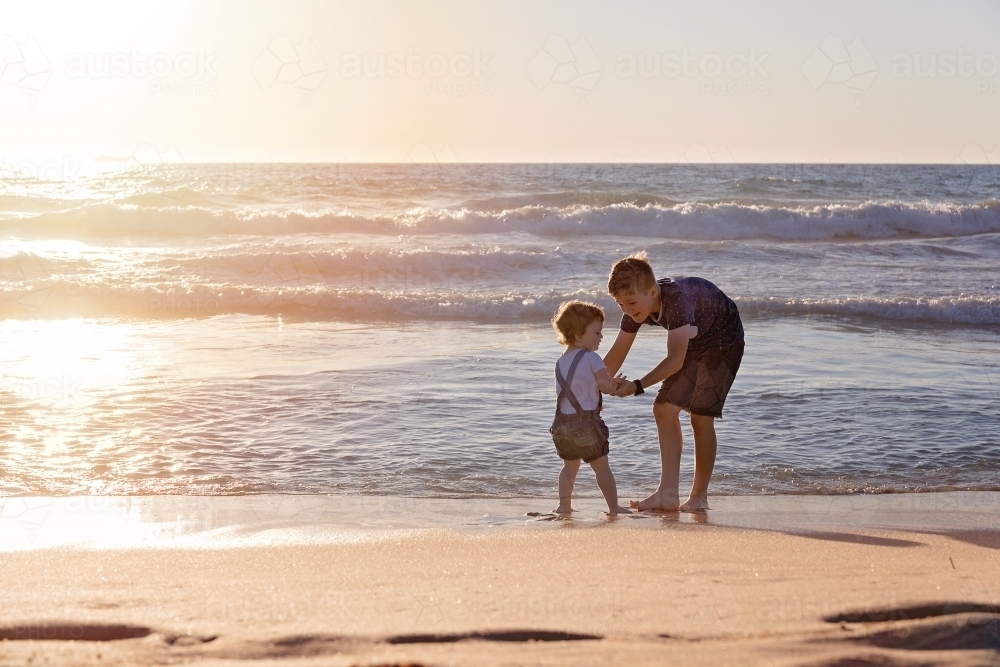 Kids Playing On The Beach At Sunset - Australian Stock Image