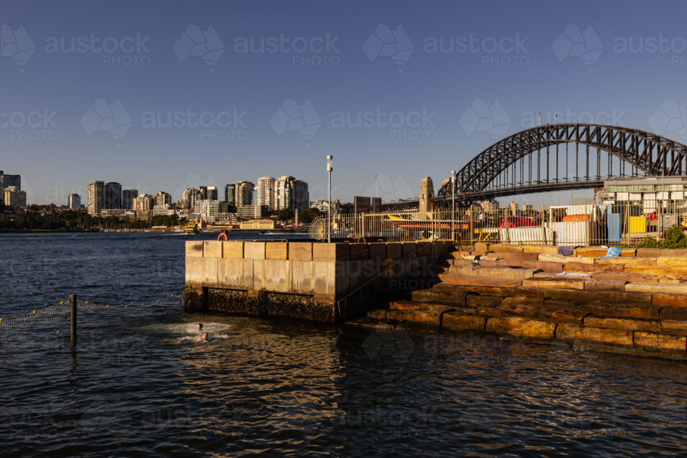 Kids swimming at Marrinawi Cove with Sydney Harbour Bridge in background - Australian Stock Image