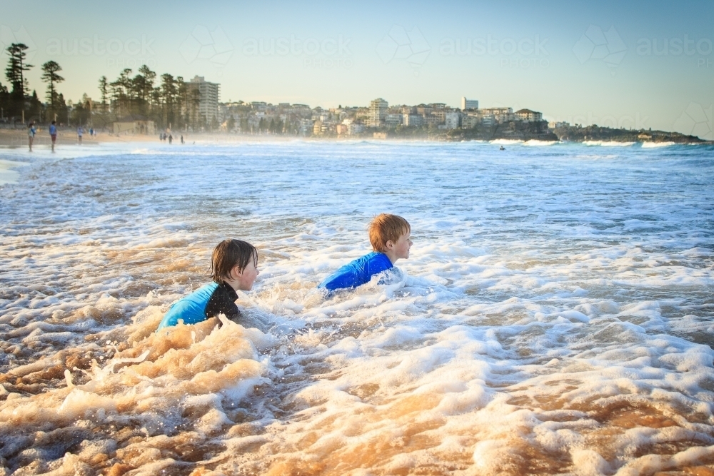 Kids swimming at the beach, Manly, Sydney, Australia - Australian Stock Image