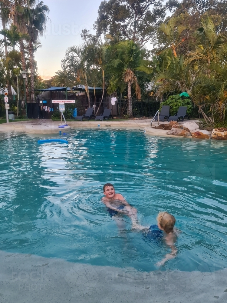 Kids swimming in resort pool at caravan park - Australian Stock Image