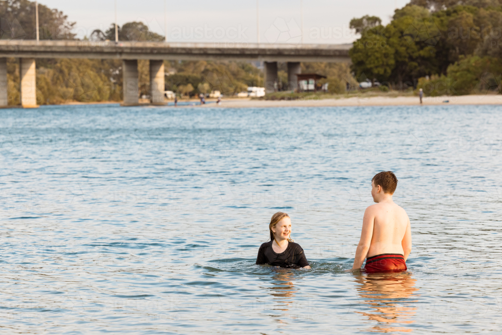 Kids swimming in the Currumbin Creek at Palm Beach in Queensland - Australian Stock Image