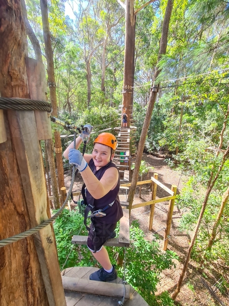 Kids taking part in a treetop climbing adventure challenge - Australian Stock Image