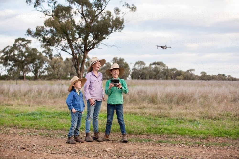 Kids using a drone on a farm - Australian Stock Image
