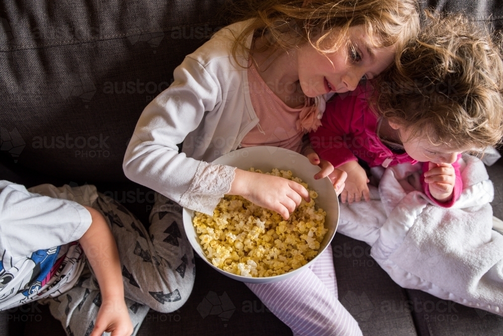Kids watching movie at home - Australian Stock Image