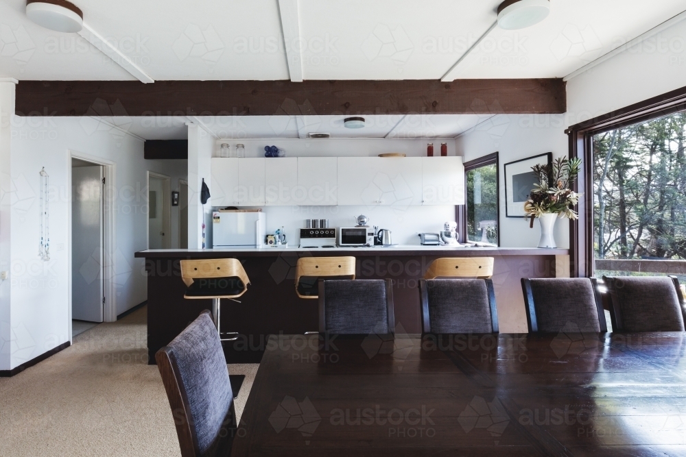 Kitchen and dining area of older style retro funky Australian beach house - Australian Stock Image