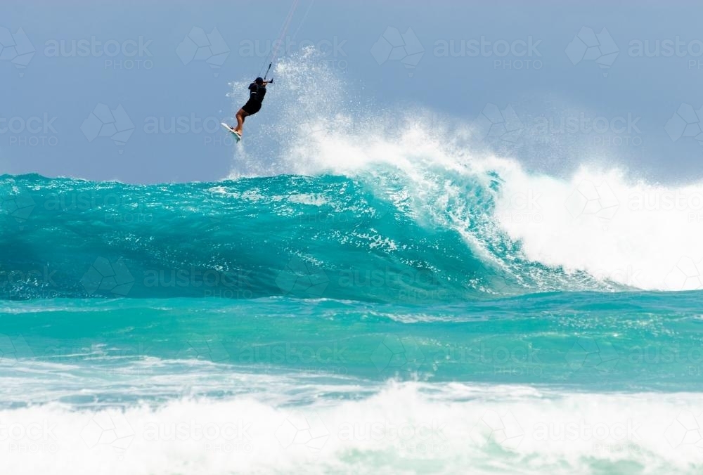 Kite surfer in the air at the top of wave - Australian Stock Image