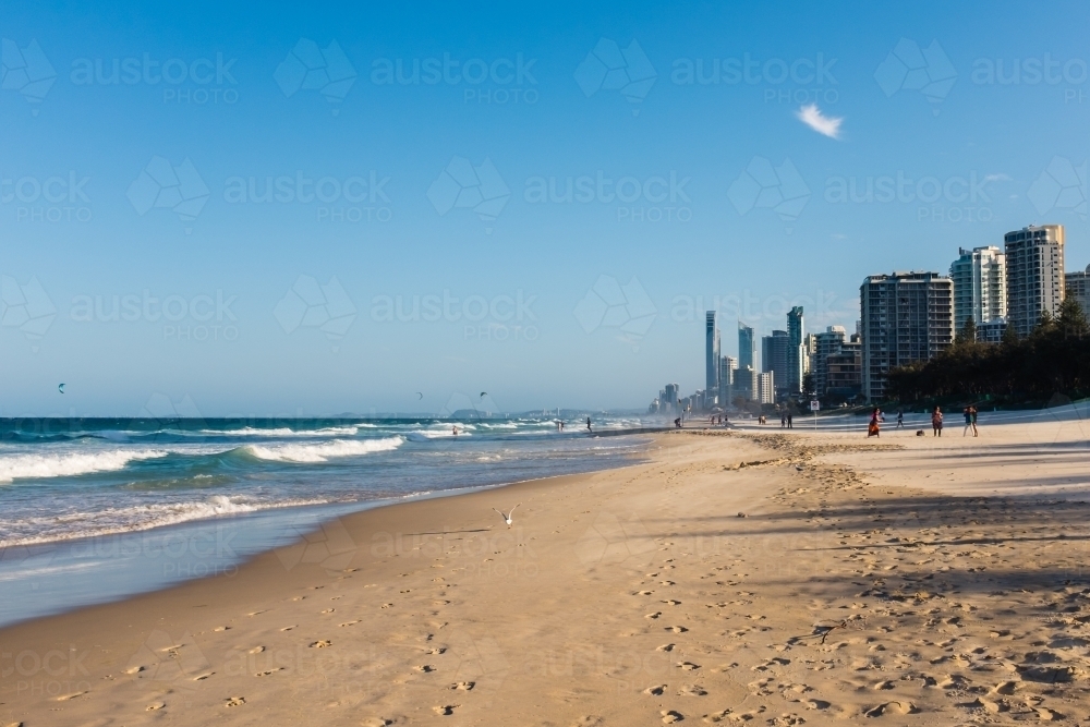 kitesurfers and tourists enjoying a windy afternoon on the gold coast - Australian Stock Image