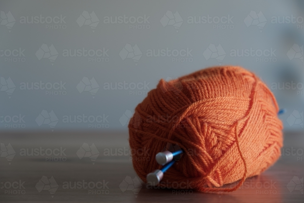 Knitting Needles with Orange Wool - Australian Stock Image