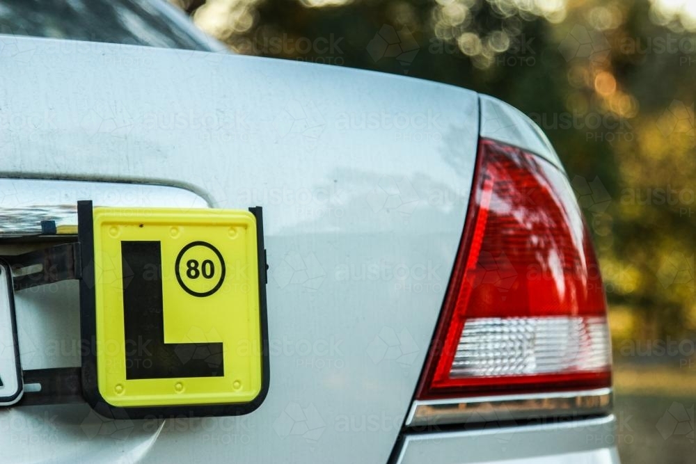 Image of L license plate on the back of a car parked outside - Austockphoto