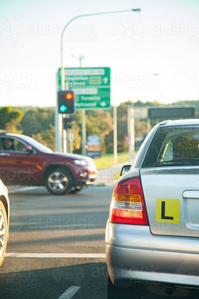 L plate car in peak hour traffic driving on road in the afternoon - Australian Stock Image