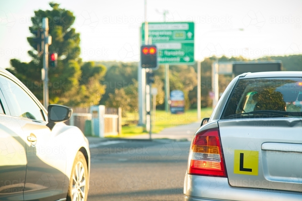 L plate car in peak hour traffic driving on road in the afternoon - Australian Stock Image