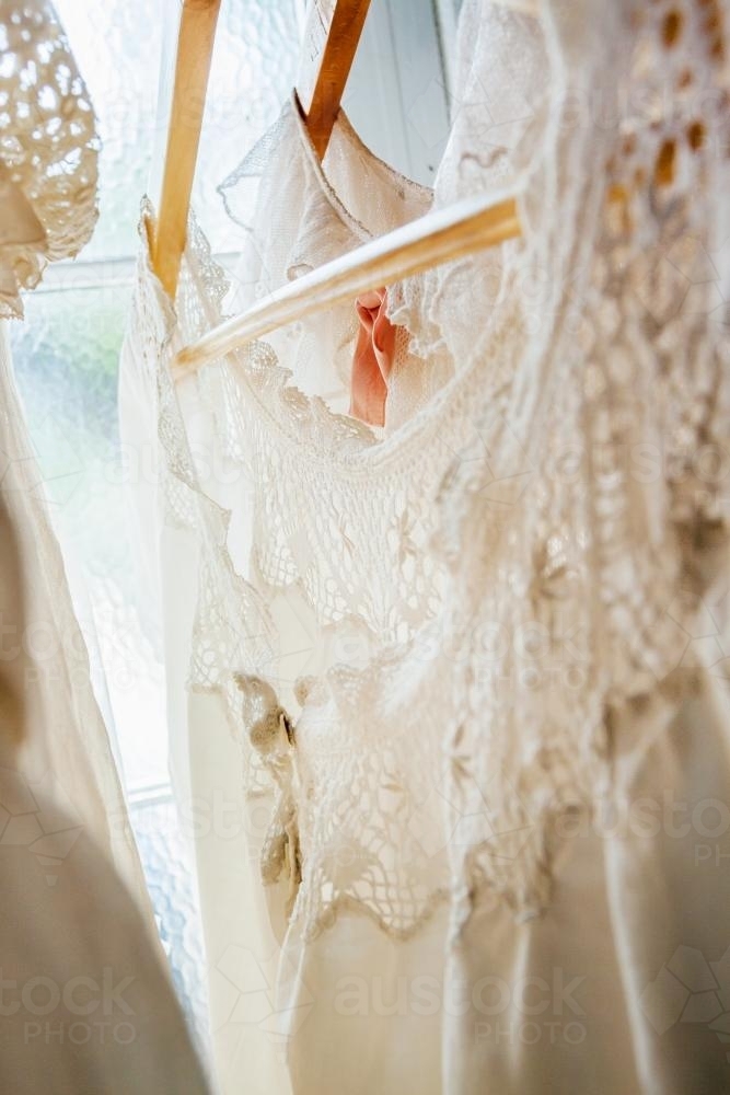 Lace dresses hanging in a window - Australian Stock Image