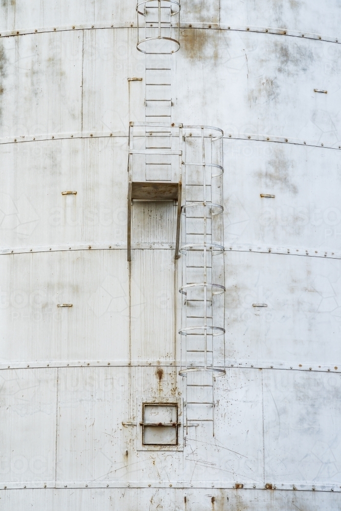Ladders going up the side of a steel grain silo - Australian Stock Image