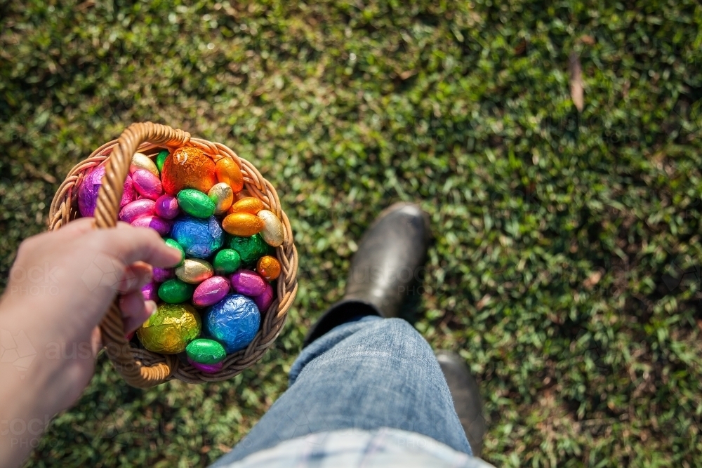 Lady holding basket ready to hide Easter eggs for Easter egg hunt - Australian Stock Image