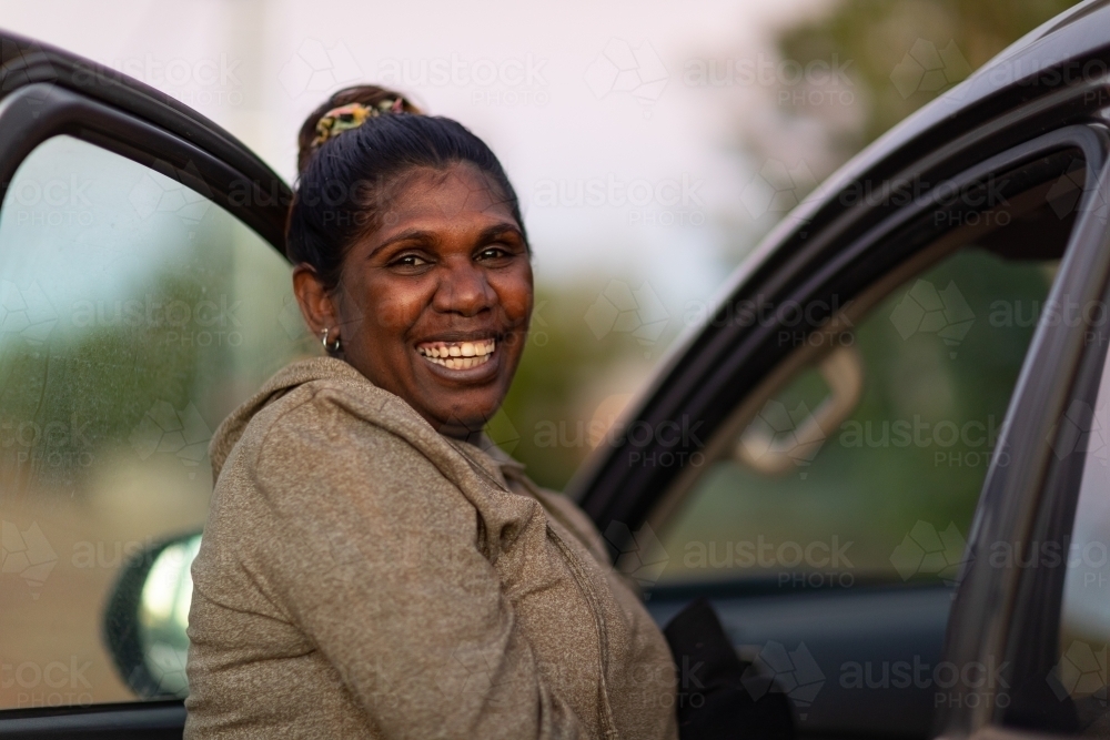 lady standing near vehicle with door open - Australian Stock Image