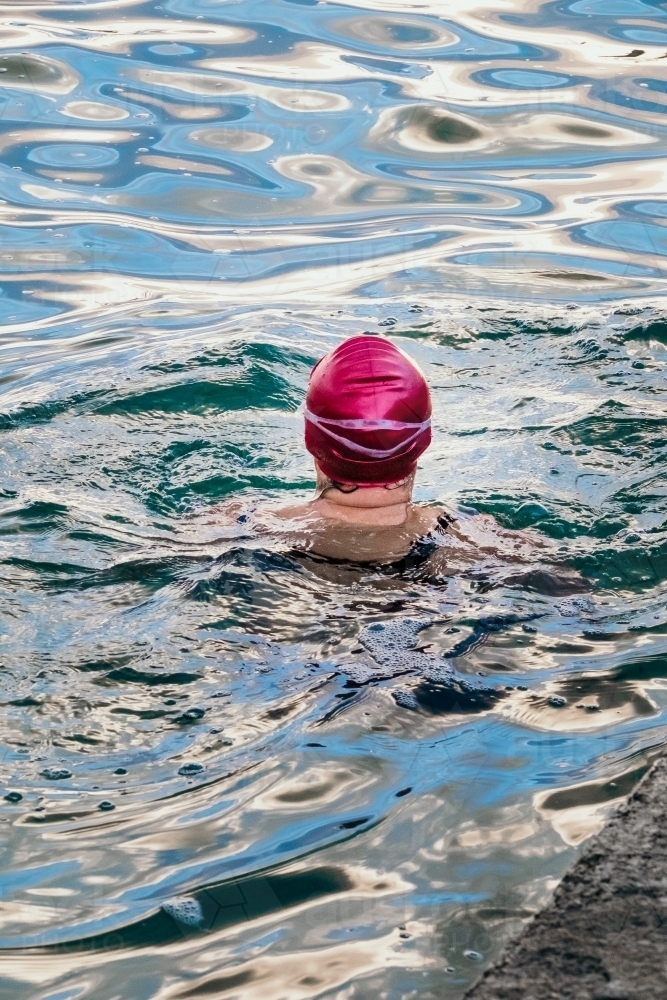 Lady swimming in the ocean pool. - Australian Stock Image