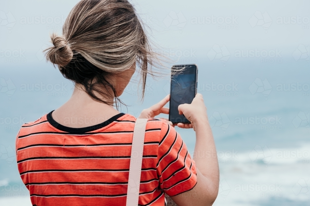 Lady taking Photo with phone. - Australian Stock Image