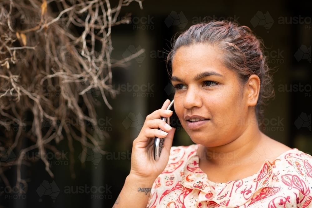 lady talking on old-fashioned  flip phone - Australian Stock Image