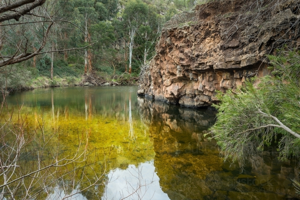 Lagoon and volcanic rock central Victoria quiet scene of billabong water and rock - Australian Stock Image