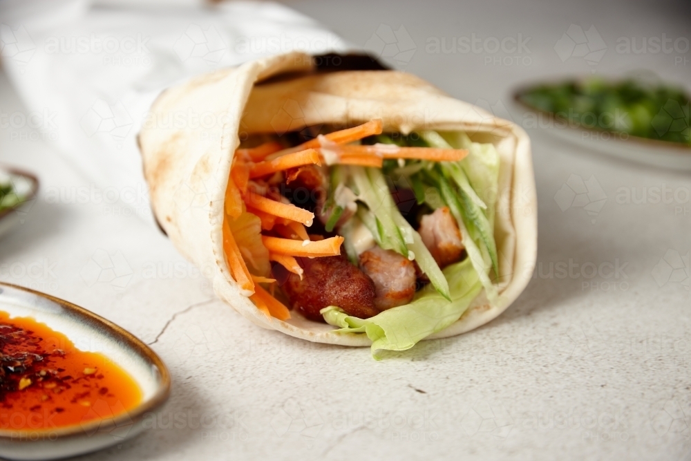 Lamb kebab wrap on table - Australian Stock Image