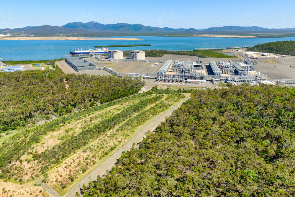 Landfill and storm water gullies with liquified natural gas in the background on Curtis Island - Australian Stock Image