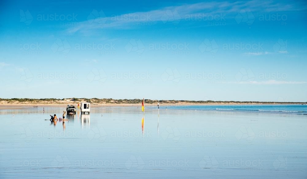 Landscape beach scene with cars and people in the distance - Australian Stock Image