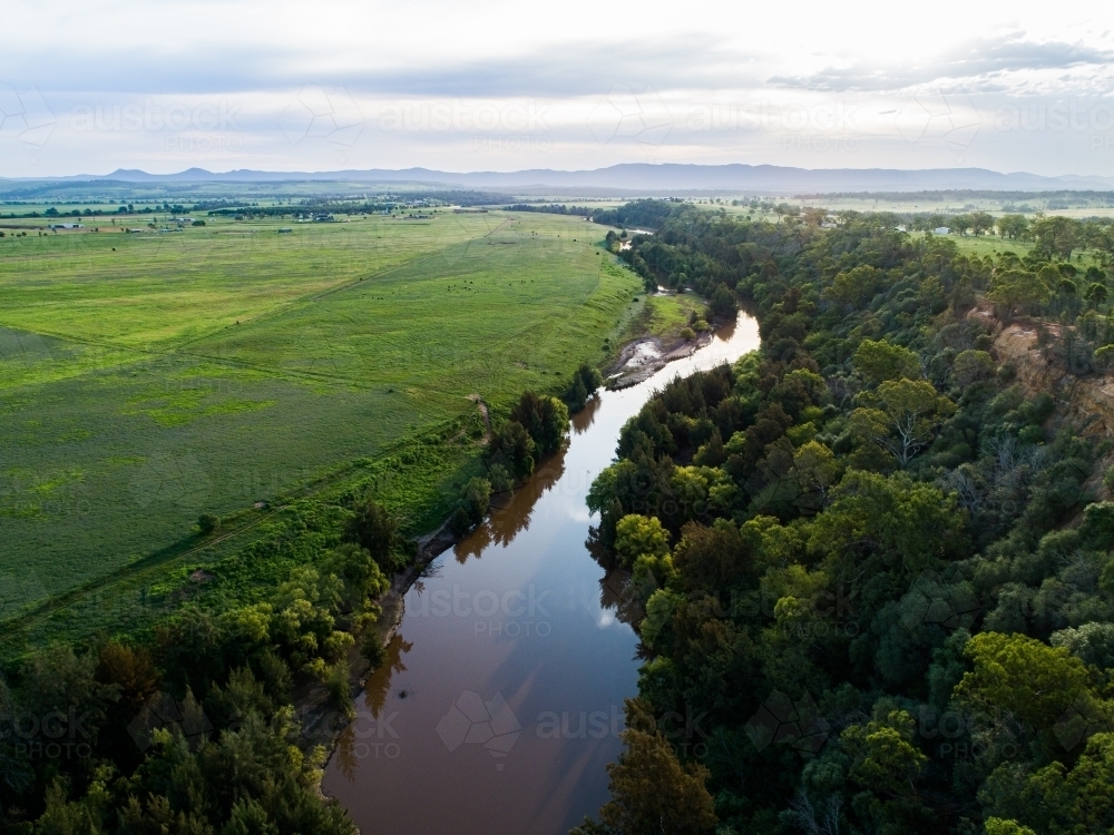 Landscape of cliff, river and green farmland - Australian Stock Image