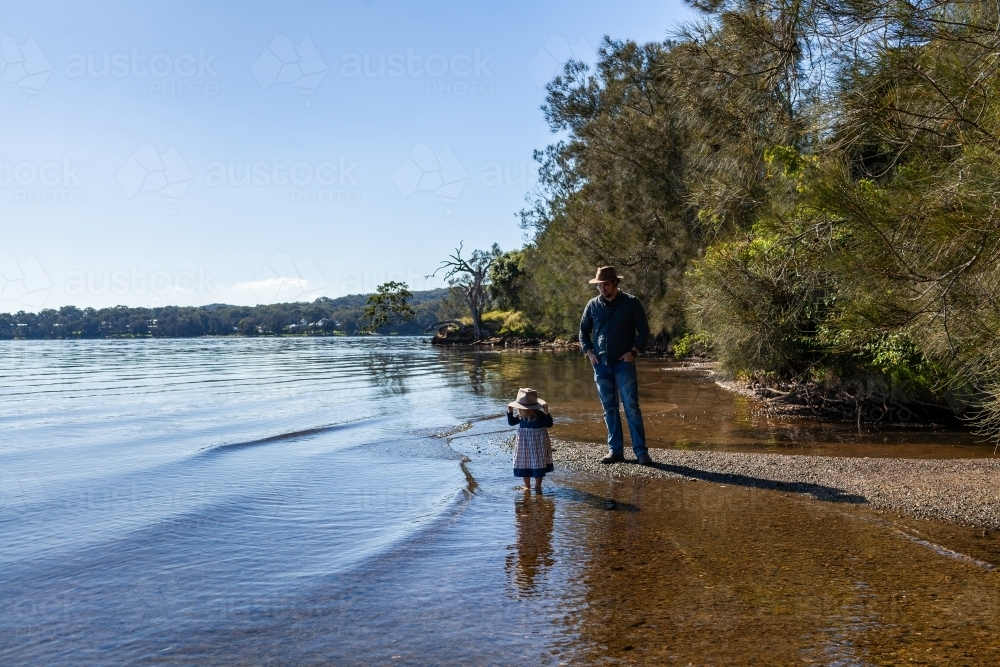 Landscape of lake shoreline with trees to shallow water - Australian Stock Image