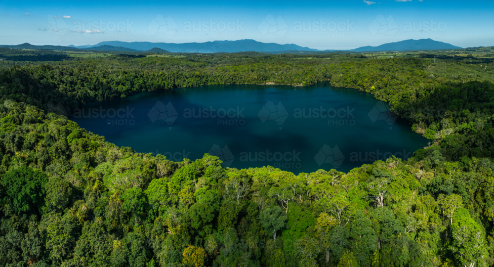 landscape of rainforest and deep blue lake - Australian Stock Image