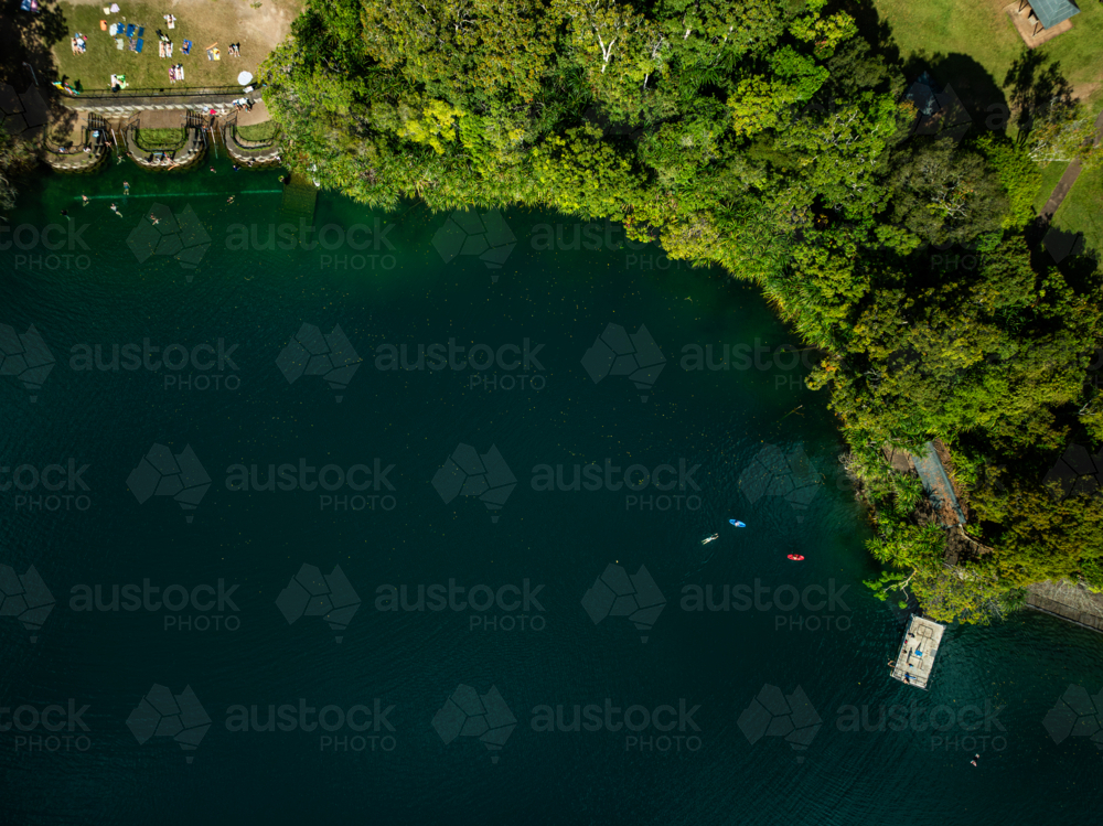 landscape of rainforest and deep blue lake - Australian Stock Image