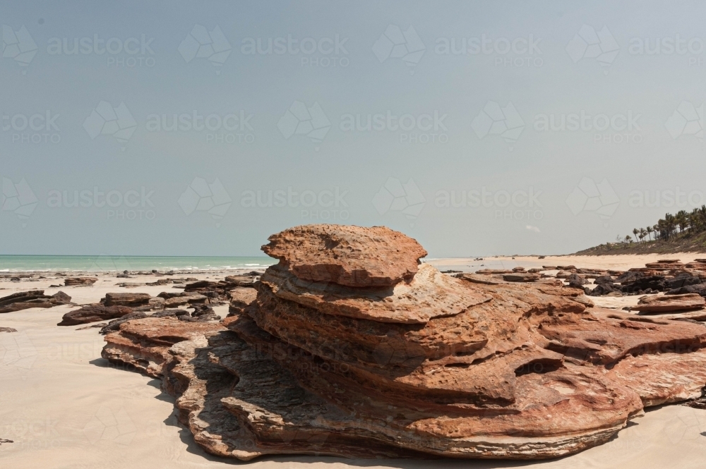 Broome Area Rocks Image of landscape of red rocks on Cable Beach Broome - Austockphoto
