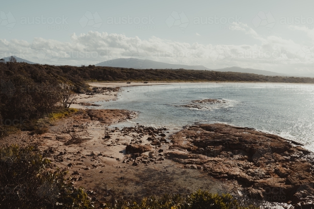 Landscape of the rocky coast and clear water at Diamond Head Beach, NSW. - Australian Stock Image