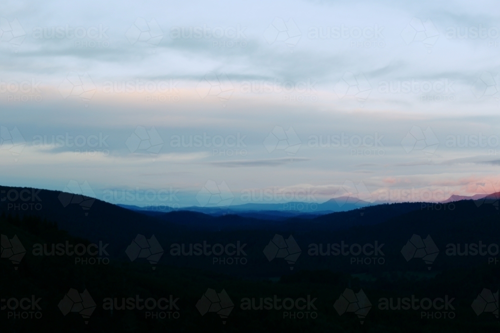 Landscape silhouette of mountains at sunset - Australian Stock Image
