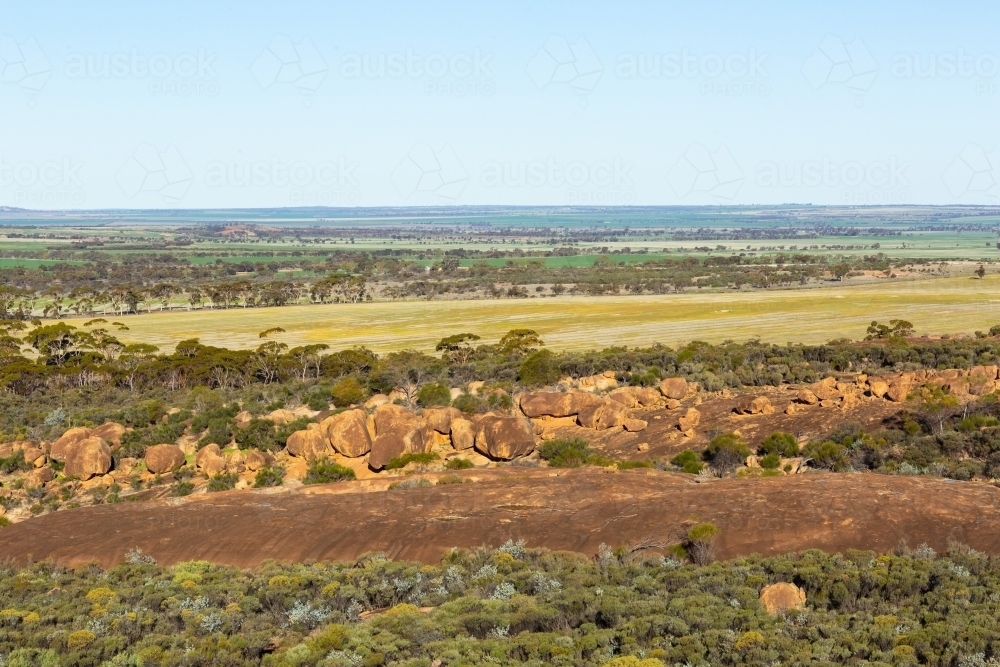 landscape view of rocks, bush and farmland in the wheatbelt - Australian Stock Image
